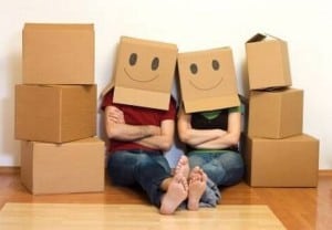 Couple moving with boxes on their heads.