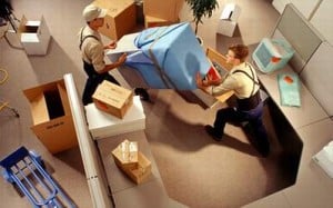 Movers moving furniture in an office.